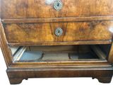 a wooden chest of drawers with a drawer underneath it
