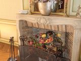 a fireplace in a room with a mirror on the wall