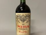 an old bottle of wine sitting on top of a table