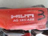 a close up of a red tool on a table