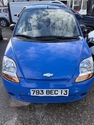 a blue car that is parked in a parking lot