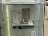 a glass display case with a lot of jewelry on it