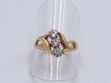 a close up of a gold ring with two diamonds on it