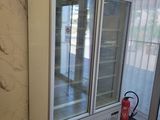 an image of a refrigerator in a room with a fire extinguisor