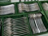 silverware in a green case on a table in a room