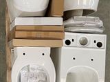 two toilets and a bowl on a shelf next to each other