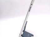 a tablet that is sitting on a stand on a white surface