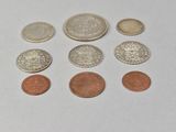 several different coins are shown on a white surface