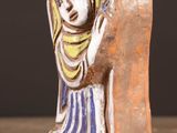 a ceramic figurine of a woman holding a baby
