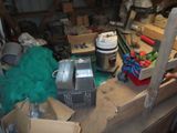 a lot of clutter in a garage with a lot of stuff on the floor