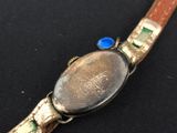 a close up of a watch on a black surface