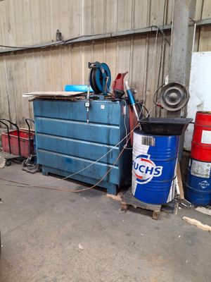 a garage with a lot of tools and a blue container