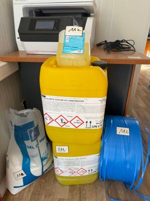 a yellow container with a blue handle next to a yellow container with a blue handle and a yellow container with a blue handle