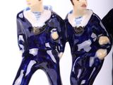 two figurines of two men standing next to each other