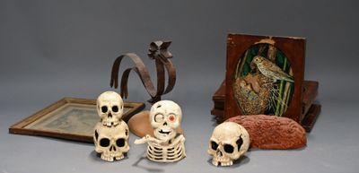 a group of skeleton figurines sitting next to a picture