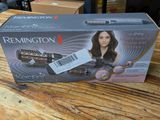 the box is open on a wooden table with a hair dryer in it