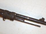 an old gun is laying on a white surface with a wooden handle