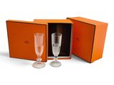 an orange box containing two champagne glasses and a wine glass