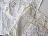 a lot of white clothing on a white table