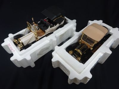 two model cars that are sitting side by side on a black background