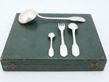 a green box with silverware on it and a spoon and fork