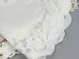 a piece of lace on a table with a heart on it