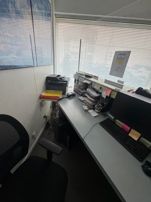 a desk with a computer and a keyboard on it
