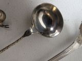 two spoons and a spoon rest on a table