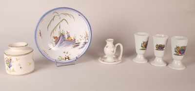 a plate, cups, and saucer sitting on a table