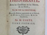 an old book that is open on a table