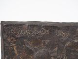 sculpture of a man riding a horse on a stone block with writing on it