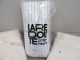 a bag of white towels sitting next to a bag of white towels