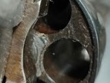 a close up of a metal object with a hole in it