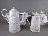 three white and blue teapots and a bowl on a gray surface