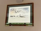 a picture hanging on the wall above a bed