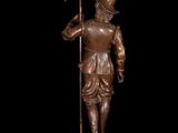 bronze statue of a man holding a flag and standing on a pedestal