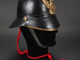 a close up of a helmet on a mannequin head on a black background