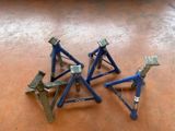 three small metal tools sitting on top of a wooden floor