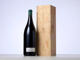 a bottle of wine sitting next to a wooden box