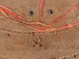 a close up of a brown hat with red thread on it