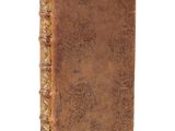 an old book with a brown leather cover on a white background