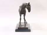 statue of a horse on a marble base on a white background