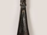 an image of a wooden spoon with a statue on it
