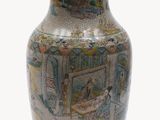 a vase with a painting on it sitting on a table