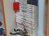 a stack of dvds on a shelf in the corner of a room