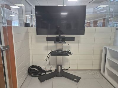 a flat screen tv sitting on a stand in the corner of a room