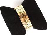 black velvet bow tie with a gold plated cuff on it