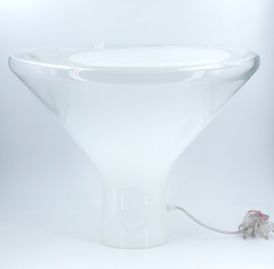 a glass vase with a mouse in it on a table