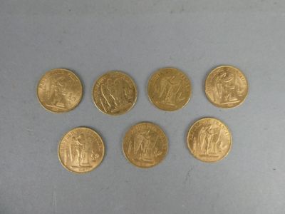 six gold coins are arranged in a circle on a gray surface