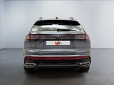 the rear end of a silver volkswagen suv parked in a white room